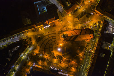 High angle view of illuminated street amidst buildings in city