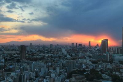 Cityscape against sky at sunset