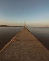 Pier over sea against clear sky