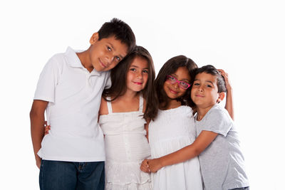 Portrait of happy friends standing against white background