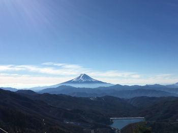 Scenic view of mountains against blue sky