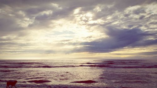 Scenic view of calm sea against cloudy sky