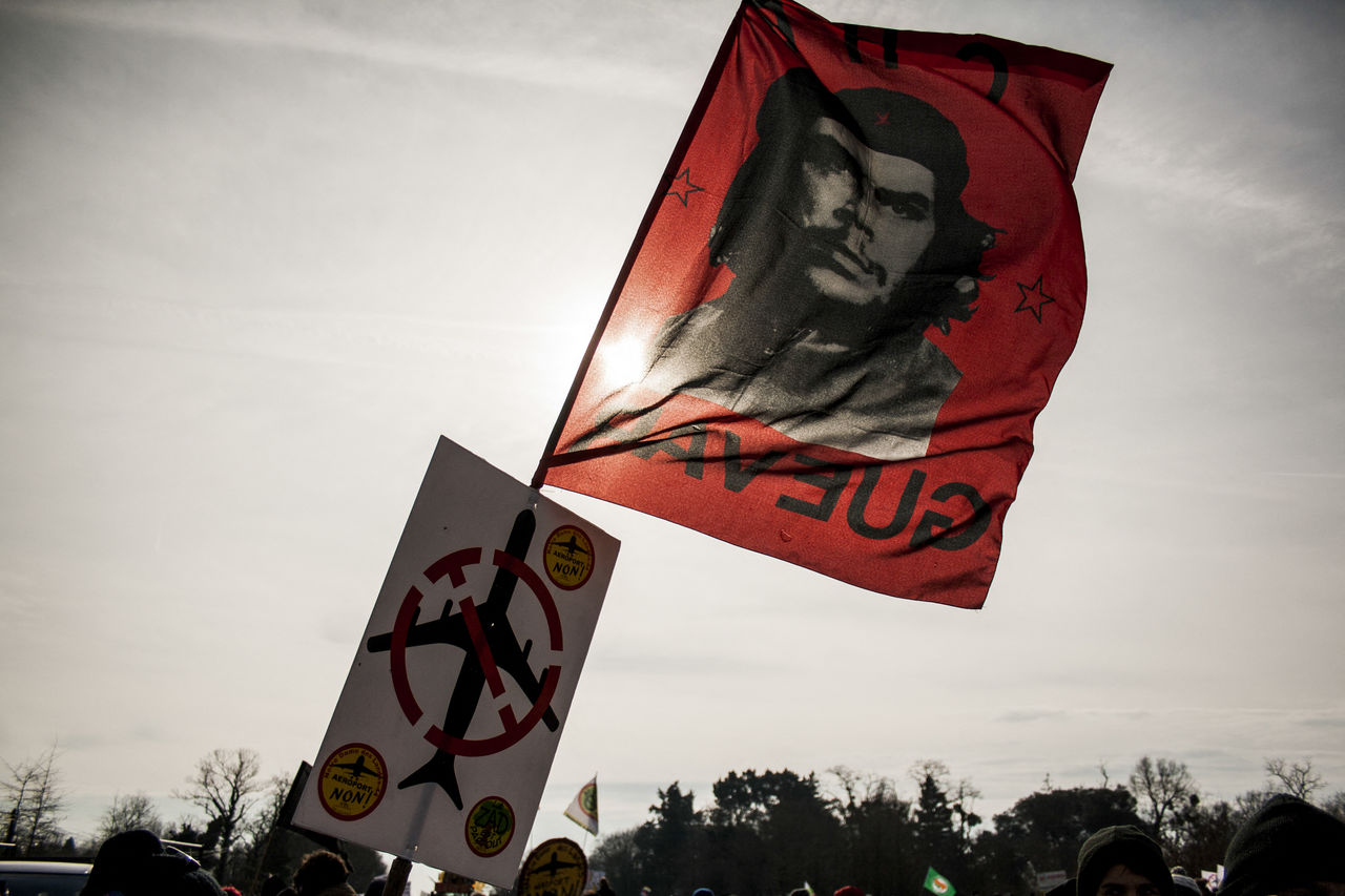 flag, sky, person, nature, group of people, human face, red, crowd, outdoors, advertising, protest, clothing