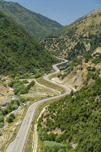 High angle view of road amidst trees against sky