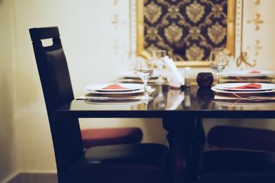 Plates and glasses on dinning table at restaurant