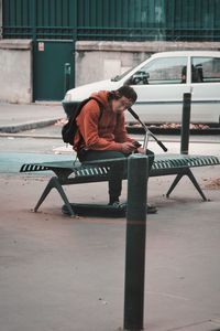 Man working on bench in city