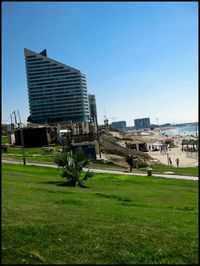 View of buildings against clear blue sky