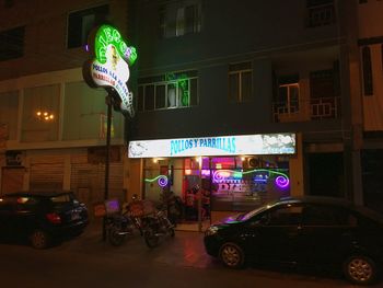 View of illuminated city street at night