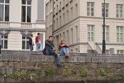 People on wall in city