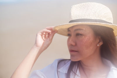 Portrait of young woman wearing hat