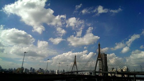 Low angle view of bridge against cloudy sky