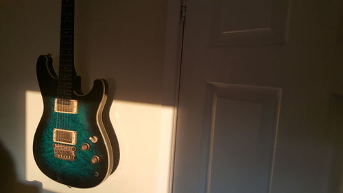 Close-up of illuminated lighting equipment on wall