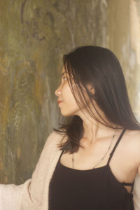 Portrait of a beautiful young woman looking away