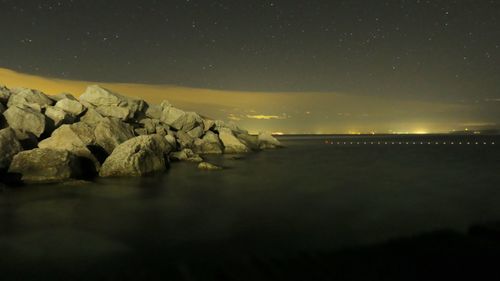 Scenic view of sea against clear sky at night