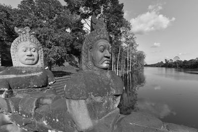 Old sculptures by river