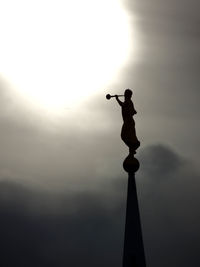 Low angle view of silhouette statue against sky during sunset