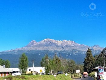 Scenic view of mountains against clear blue sky