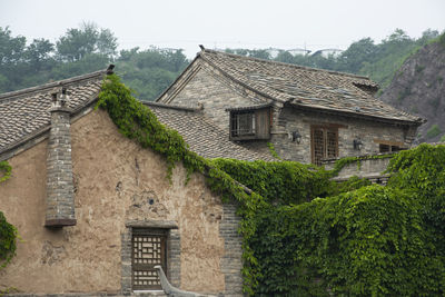 Exterior of house by building against sky