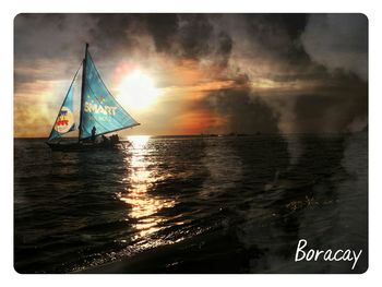 Boat sailing in sea at sunset