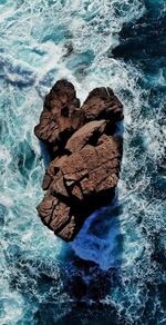 High angle view of rock formation in sea