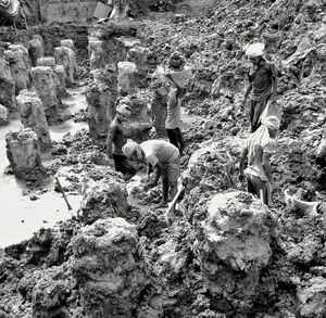 High angle view of men working on rock