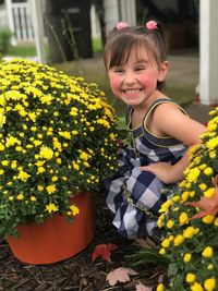 Portrait of smiling girl with yellow flowers