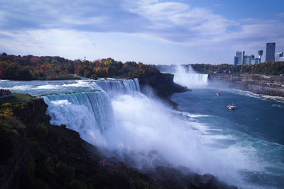 Scenic view of waterfall against sky