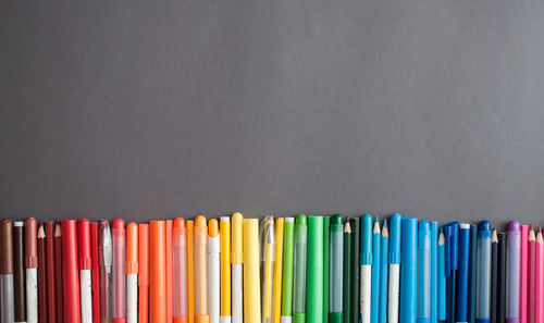 Close-up of multi colored pencils against black background