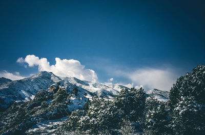 Scenic view of snowcapped mountains against blue sky