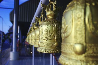 Close-up of gold bells at temple