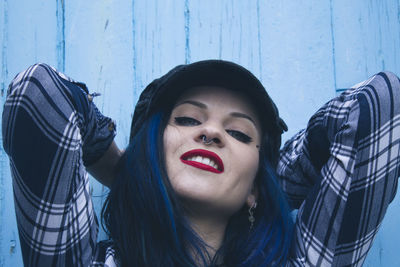 Hipster girl on blue wall