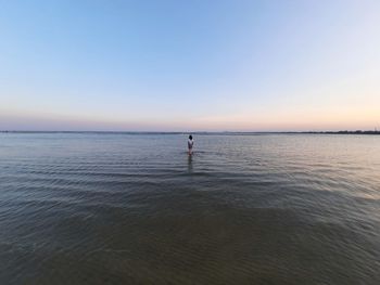 Scenic view of sea against clear sky during sunset