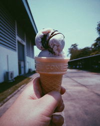 Hand holding ice cream cone