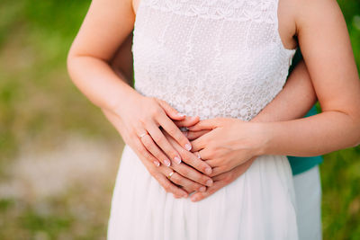 Midsection of couple holding hands