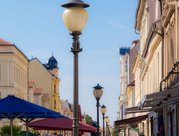 Street light against sky in city