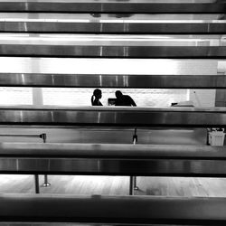 Silhouette people seen through metal steps