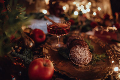 Christmas academia vintage harry potter table - fir, candles, wine, red decor, glasses, gingerbread