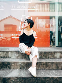 Young woman sitting on steps