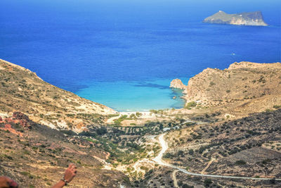 Scenic view of sea and mountains against blue sky