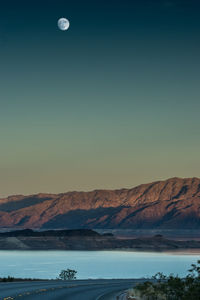 Scenic view of lake and mountains against clear sky