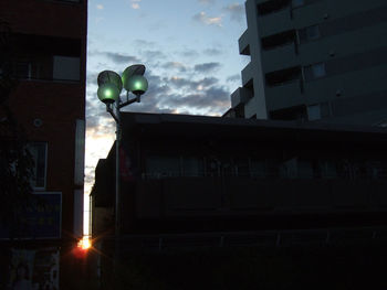 Low angle view of street light against building at night