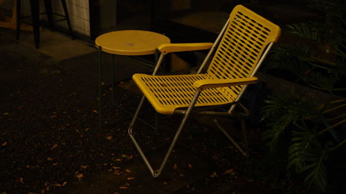 High angle view of empty chair and table in yard