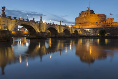 Ponte sant angelo over tiber river in city at dusk