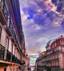 Buildings in city against cloudy sky