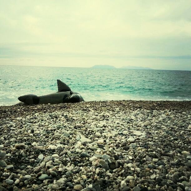 sea, beach, horizon over water, water, sky, shore, tranquility, tranquil scene, scenics, beauty in nature, transportation, nature, cloud - sky, pebble, rock - object, sand, stone - object, cloud, idyllic, mode of transport