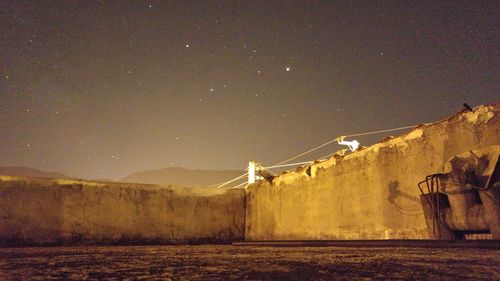 Built structure against sky at night