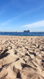 Scenic view of beach against blue sky