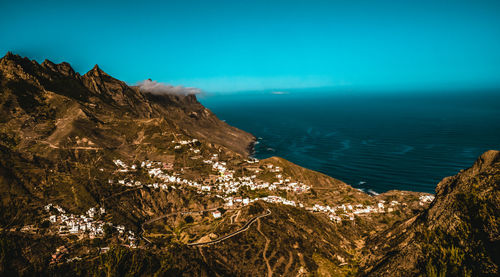 Aerial view of townscape against sea and sky