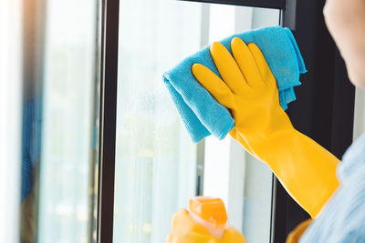 Midsection of person working with window