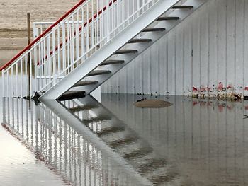 View of birds on bridge over lake